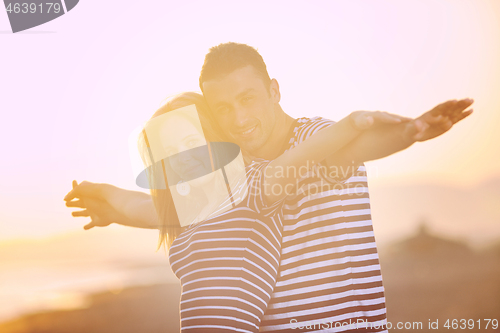 Image of happy young couple have romantic time on beach