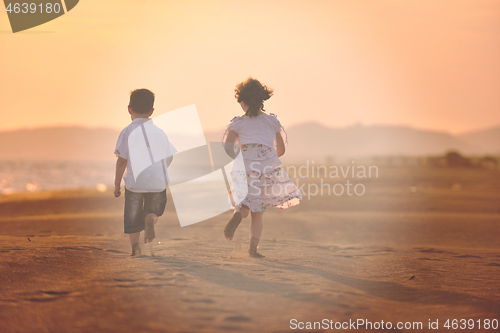 Image of happy young family have fun on beach at sunset