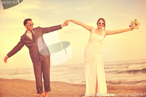 Image of romantic beach wedding at sunset