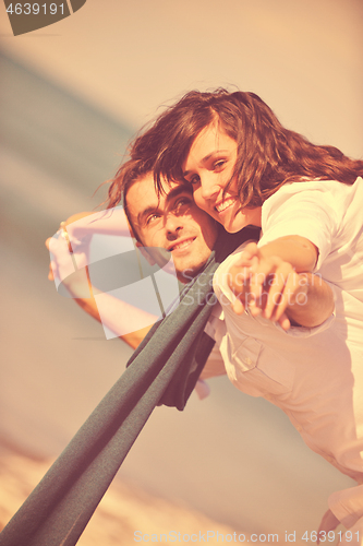 Image of happy young couple have fun at beautiful beach