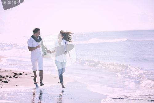 Image of happy young couple have fun at beautiful beach