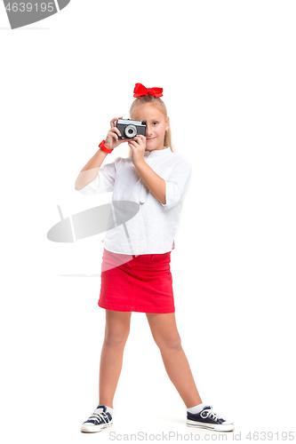 Image of Full length portrait of cute little kid in stylish clothes with retro camera