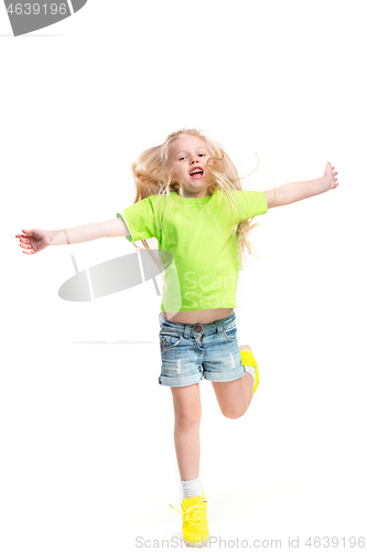 Image of Full length portrait of cute little kid in stylish jeans clothes looking at camera and smiling