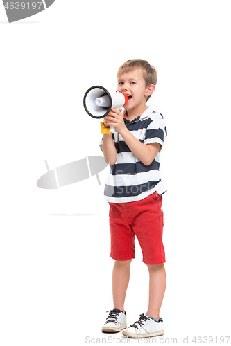 Image of Little cute kid baby boy holding in hand and speaking in electronic gray megaphone