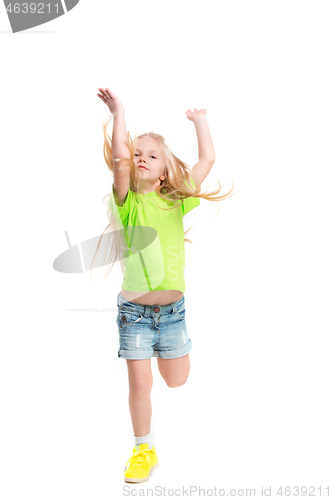 Image of Full length portrait of cute little kid in stylish jeans clothes looking at camera and smiling