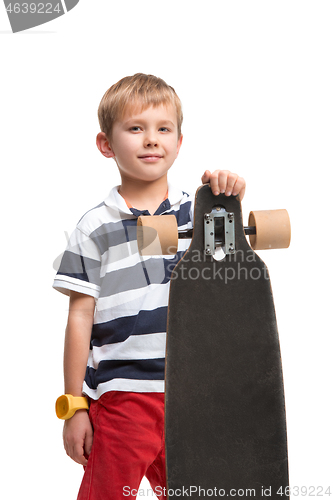 Image of Full length portrait of an adorable young boy riding a skateboard isolated against white background