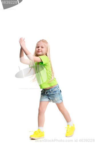 Image of Full length portrait of cute little kid in stylish jeans clothes looking at camera and smiling