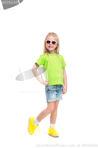 Image of Full length portrait of cute little kid in stylish jeans clothes looking at camera and smiling
