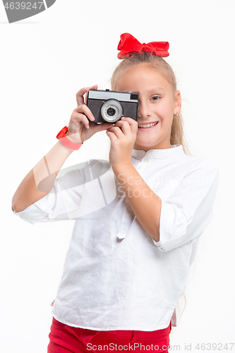 Image of Full length portrait of cute little kid in stylish clothes with retro camera