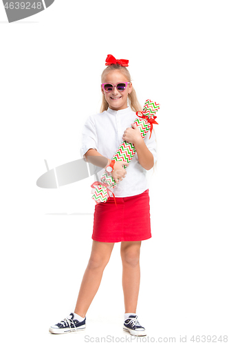 Image of Full length portrait of cute little kid in stylish clothes looking at camera and smiling