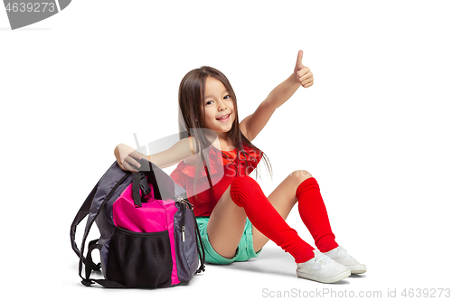 Image of Full length portrait of cute little kid in stylish jeans clothes looking at camera and smiling