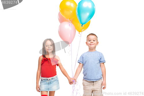 Image of Full length portrait of cute little kids in stylish clothes looking at camera and smiling