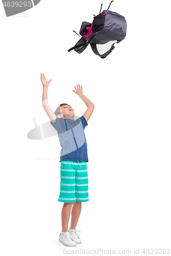 Image of Full length portrait of cute little kid in stylish clothes jumping with bag