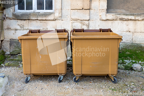 Image of Two Brown Dumpsters