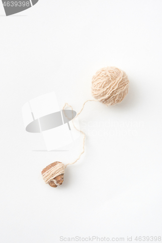 Image of Ball of natural woolen thread on a white background. Top view.