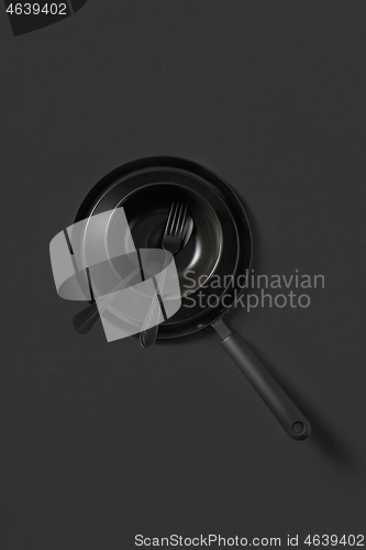 Image of Set of different cooking empty utensil black colored on the same color background.