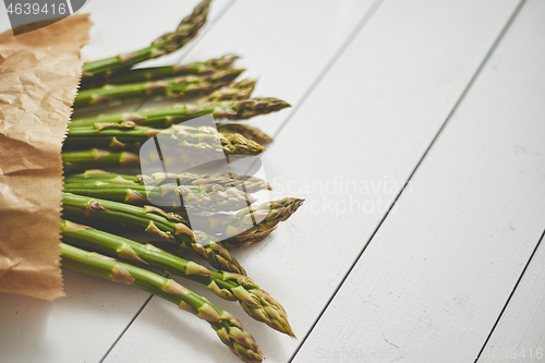 Image of Fresh green asparagus in a brown paper bag. Healthy eating concept. Food for vegetarians