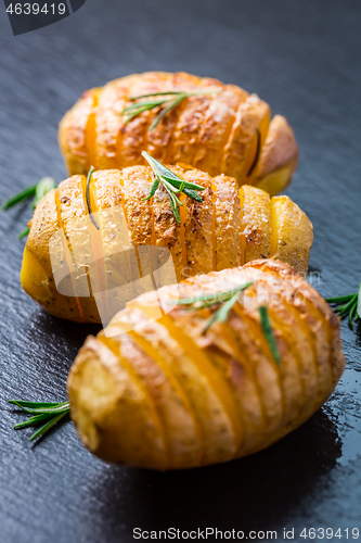 Image of Hasselback potatoes. Backed potatoes from Sweden with garlic and herbs