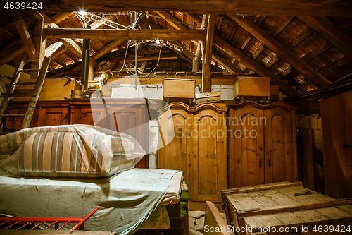 Image of Interior of old wooden shed with scrap wood with sunrays 