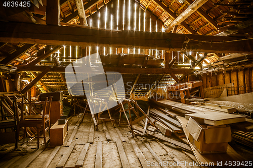 Image of Interior of old wooden shed with scrap wood with sunrays 