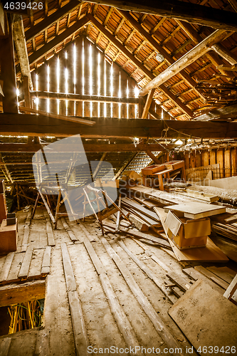 Image of Interior of old wooden shed with scrap wood with sunrays 