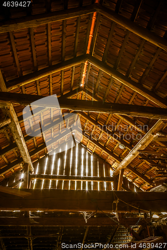 Image of Interior of old wooden shed with scrap wood with sunrays 