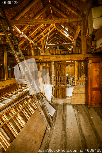 Image of Interior of old wooden shed with scrap wood with sunrays 