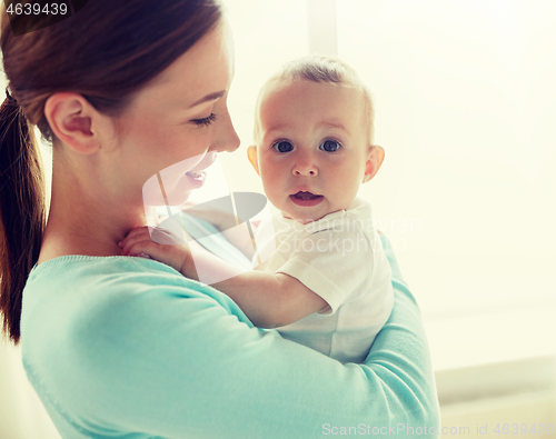 Image of happy young mother with little baby at home