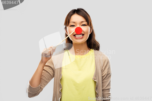 Image of happy asian woman with red clown nose