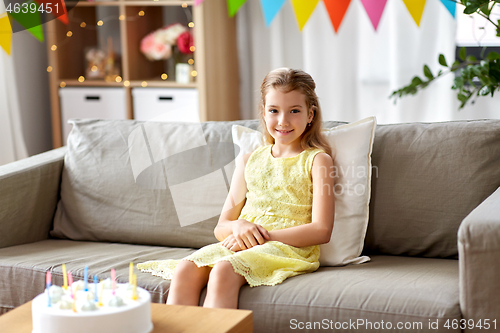 Image of happy birthday girl with cake at home party