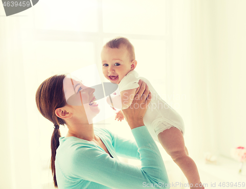 Image of happy young mother with little baby at home