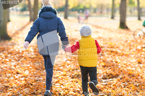 Image of happy children running at autumn park