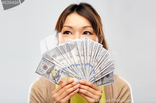 Image of asian woman with hundreds of dollar money