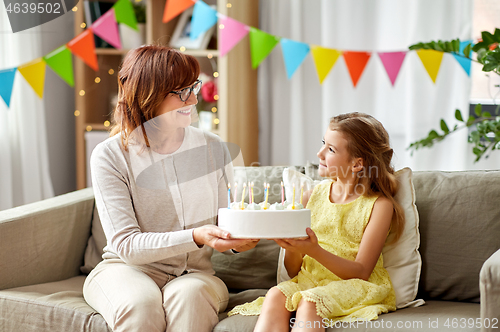 Image of grandmother and granddaughter with birthday cake