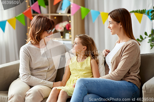 Image of mother, daughter and grandmother at birthday party