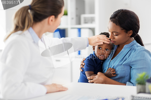 Image of mother with sick baby son and doctor at clinic