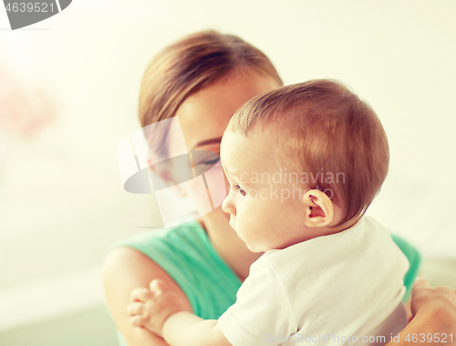 Image of happy young mother with little baby at home