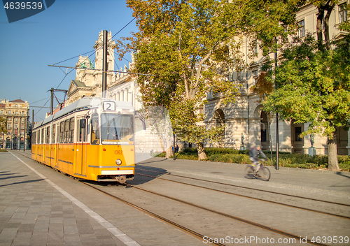 Image of Yellow tram moving along city road in Budapest, Hungary.