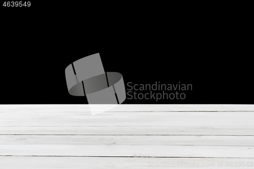 Image of Blank grey wooden table for display or montage your products on a black background.