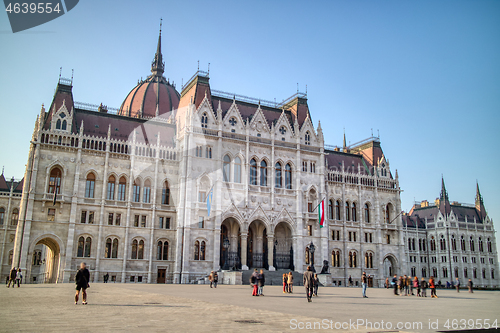 Image of The Hungarian paliament building with walking people around square, Budapest.