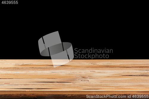 Image of Retro wooden table on a black background can used for display or montage your products.