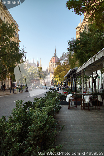 Image of Town street with sidewalk cafe with view to Hungarian paliament building.