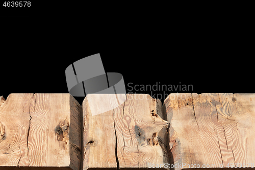 Image of Retro rough wooden table for display or montage your products on a black background.