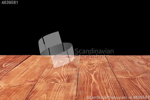 Image of Aged natural wooden table for montage and present your products on a black background.