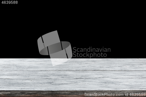 Image of Retro wooden grey table on a black background can used for present or montage your products.