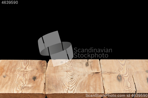 Image of Wooden table on a black background can used for display or montage your products.