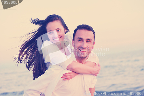 Image of young couple  on beach have fun