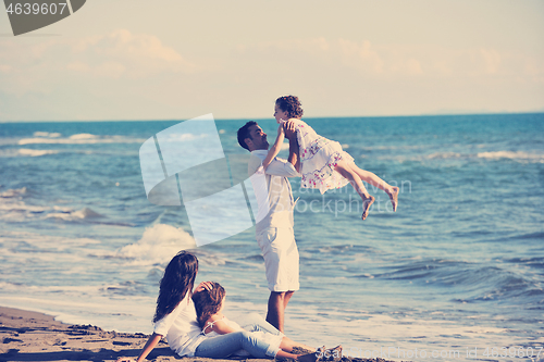 Image of happy young  family have fun on beach