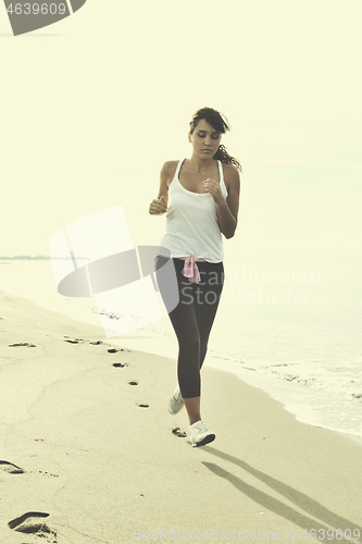 Image of woman running on beach