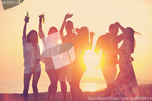 Image of Group of young people enjoy summer  party at the beach